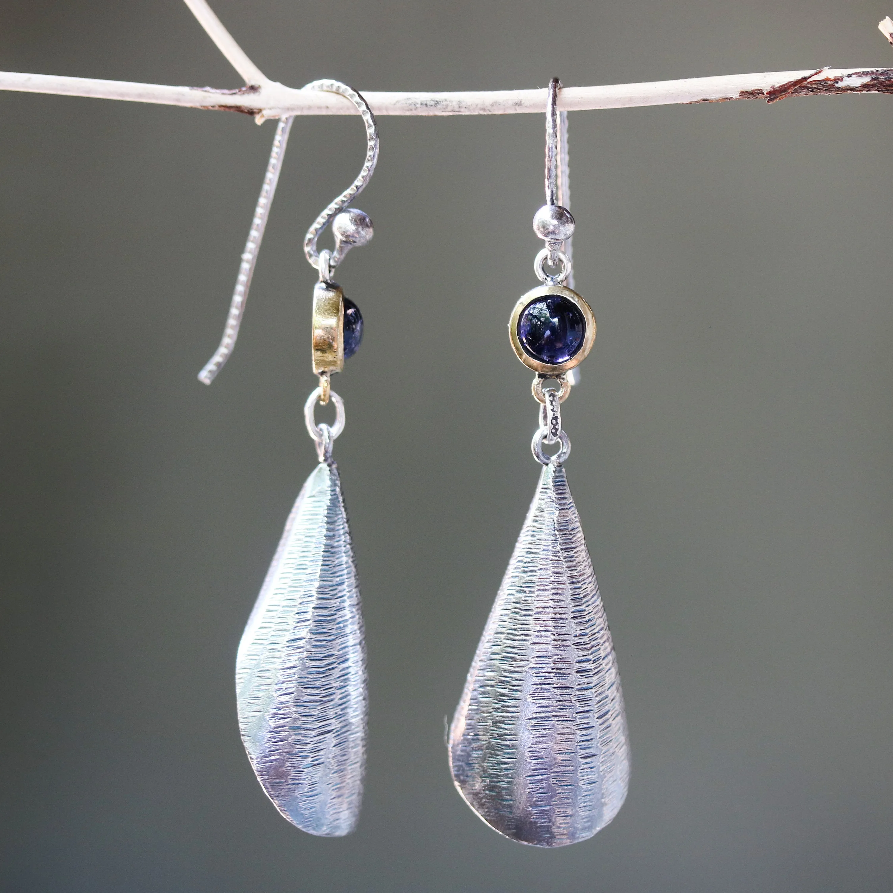 Silver leaf shape earrings with textured and tiny Iolite in brass bezel setting on oxidized sterling silver hooks style